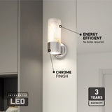 A modern wall sconce with a chrome finish and marble-patterned cylindrical shade is mounted on a white wall. Text highlights its integrated LED, energy efficiency, and 3-year warranty.