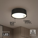 Modern matte black LED ceiling light with a ribbed design, mounted on a beige ceiling above wood-panelled walls. Text highlights its matte black finish, energy efficiency, 3-year warranty, and integrated LED.