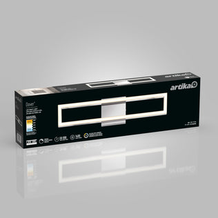 A rectangular Artika Dover modern LED bathroom vanity light 5 CCT box in black and gray, showing the fixture image, product details, energy info, and branding, with a reflection on a gray background.