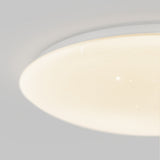 Close-up of a round, ceiling-mounted LED light fixture with a smooth, white surface illuminated, featuring small dots that resemble stars or a starry sky effect.