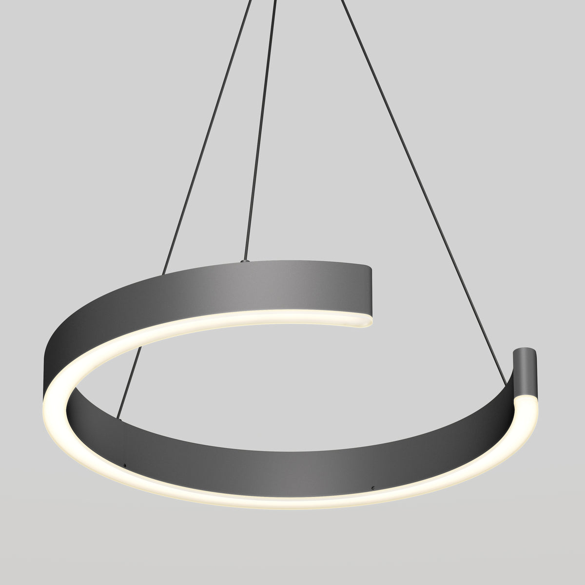 A modern, circular black pendant light hangs from the ceiling by three thin wires. The light fixture has an open ring design with built-in LED illumination along the inner edge, set against a plain gray background.