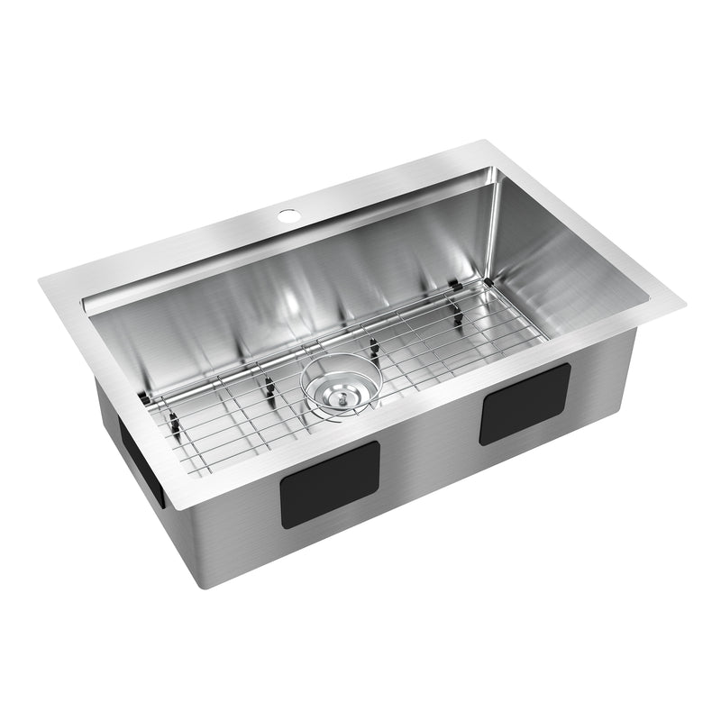 The Artika Newport 33 in. single bowl stainless steel workstation sink features a rectangular basin, center drain, bottom metal rack, pre-drilled faucet hole on the back edge, and visible black soundproofing pads on the sides.