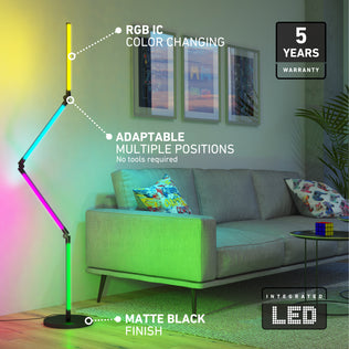 A modern living room features the Artika Fitch smart foldable RGB LED gaming floor lamp. Beside a gray sofa with colorful pillows, text highlights its color-changing LEDs, adjustable design, and 5-year warranty.