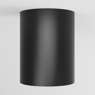 The Artika Radius LED flush mount light 3 CCT, a black cylindrical fixture, is mounted on a white ceiling and viewed from below.