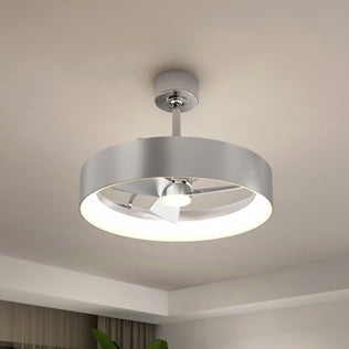 The Artika Austin 23 in. LED modern ceiling fan, featuring a circular silver fixture and quiet motor, is mounted on a white ceiling in a contemporary room with minimal decor. Includes remote control.