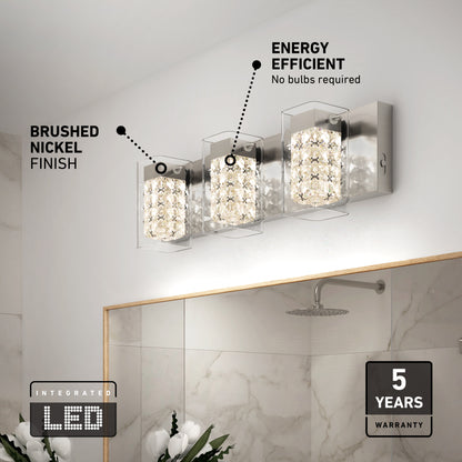 A modern bathroom light with three crystal-like LED fixtures on a brushed nickel base is mounted above a mirror. Text highlights the brushed nickel finish, energy efficiency, and a 5-year warranty.