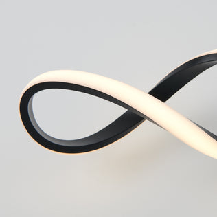 The Artika Swirl LED bathroom vanity light features a modern black and white infinity loop design, beautifully illuminated against a plain light gray background.