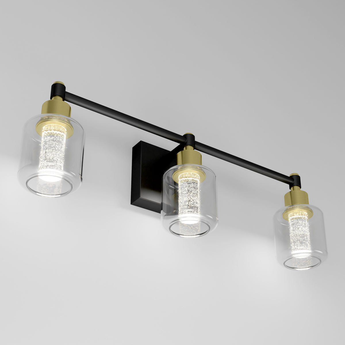 The Artika Champagne Globe bathroom vanity light features three glass and brass globes on a black bar.