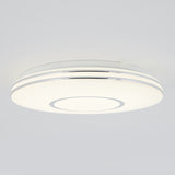 A modern, round ceiling light fixture with a sleek white design and subtle silver accents, mounted on a plain light-colored ceiling.