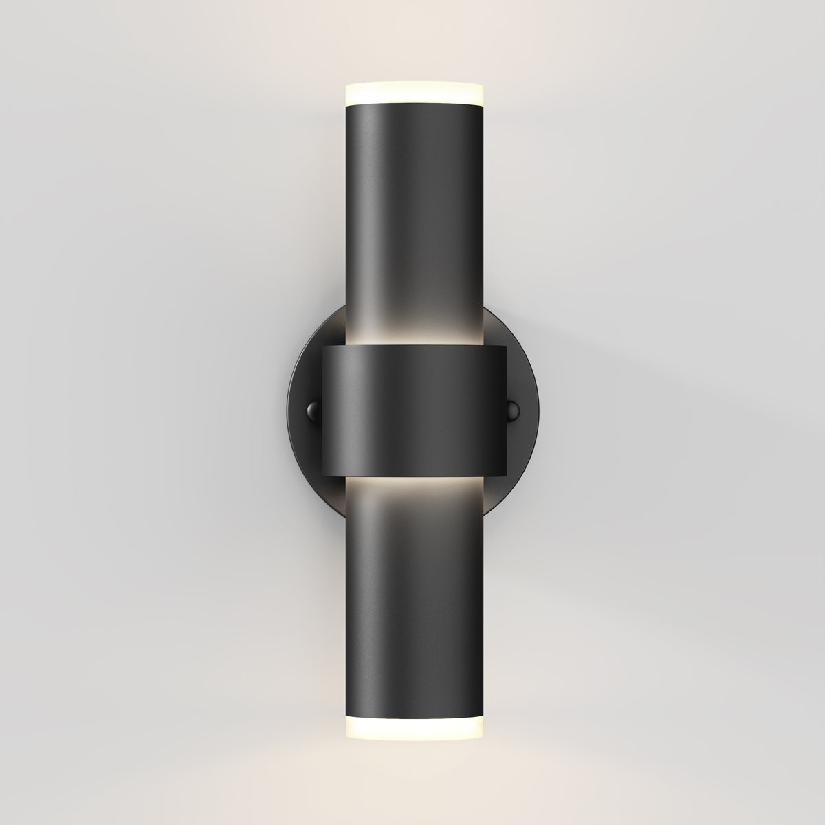 The Artika Dani modern LED indoor-outdoor wall light 5 CCT features a sleek cylindrical black design on a round base, emitting light from both the top and bottom against a light gray wall.