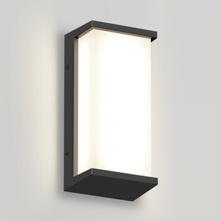 The Artika Faro modern LED indoor-outdoor wall light 3 CCT features a rectangular black frame and frosted white panel, mounted on a light gray wall to emit a soft, diffused glow.