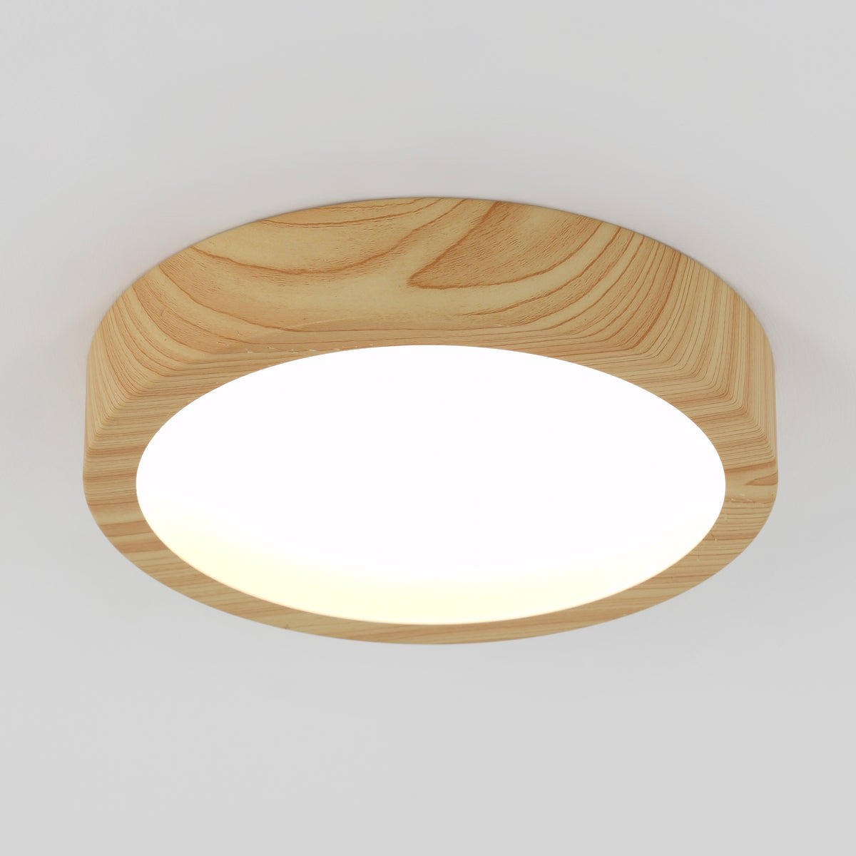 The Artika Dryad 10 in. Modern LED Flush Mount Ceiling Light features a dimmable, minimalist wood frame and 5 CCT options.