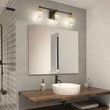 A modern bathroom with a wooden countertop, round white vessel sink, black faucet, soap dispenser, and a large mirror. Three glass pendant lights are mounted above the mirror, and a window reflects in the mirror.