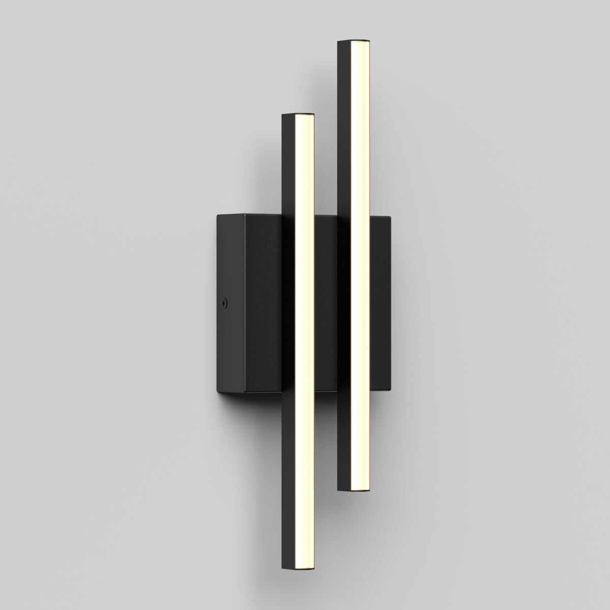 A modern wall sconce featuring two vertical, cylindrical LED light bars mounted on a rectangular black base, set against a plain light gray background.