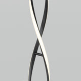 A modern floor lamp with two intertwined, curved light strips, one black and one illuminated white, creating an elegant, twisting design against a plain gray background.