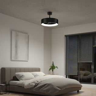 A modern bedroom featuring a low gray bed, white bedding, a potted plant, abstract wall art, large windows with blinds, and the Artika Aiden 24 in. LED modern ceiling fan with 3 speeds and remote.