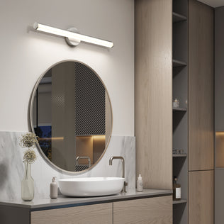 Modern bathroom with a round mirror, vessel sink, and Artika Ewen modern LED vanity light 5 CCT for perfect mirror lighting.