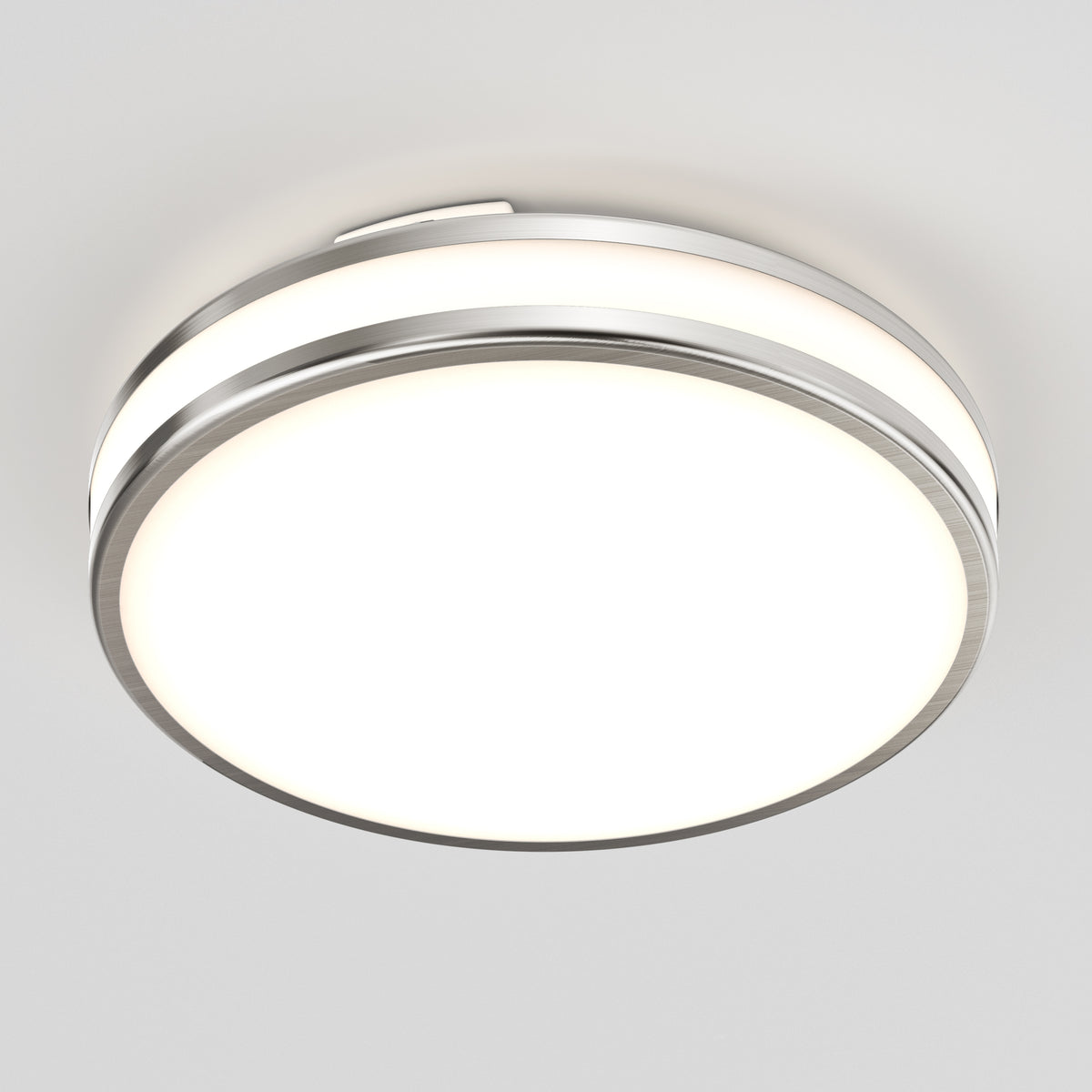 The Artika Hemisphere 15 in. LED flush mount light features adjustable brightness, a metallic edge, and a frosted white cover—perfect for bathroom lighting on plain white ceilings.