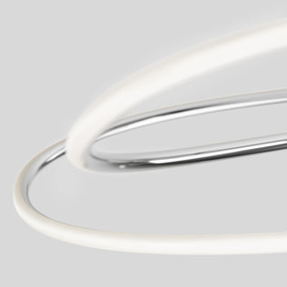 The Artika Swirl Butterfly LED contemporary pendant light features metallic and white tubes that intertwine against a plain light gray background, forming an abstract, minimalist design.