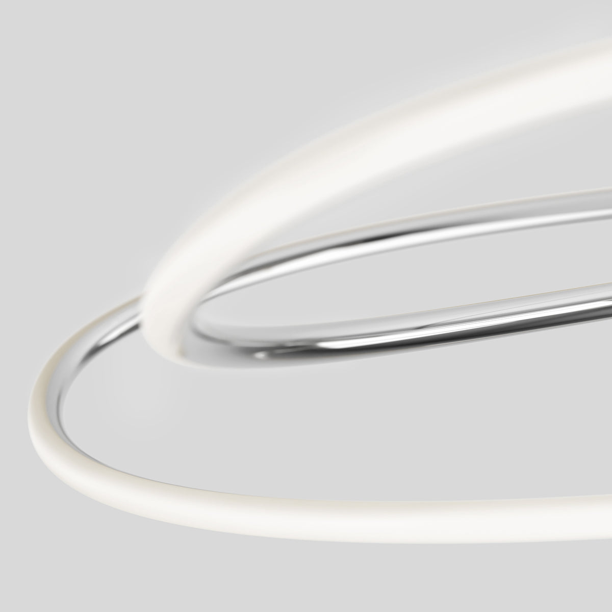 Close-up of two intertwined, smooth rings—one metallic silver, one glowing white—set against a light gray background, creating an abstract, modern composition.