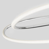 Close-up of two intertwined, smooth rings—one metallic silver, one glowing white—set against a light gray background, creating an abstract, modern composition.