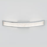 A modern wall-mounted light fixture with a curved rectangular shape, chrome edges, and a textured, illuminated center panel, set against a plain white background.