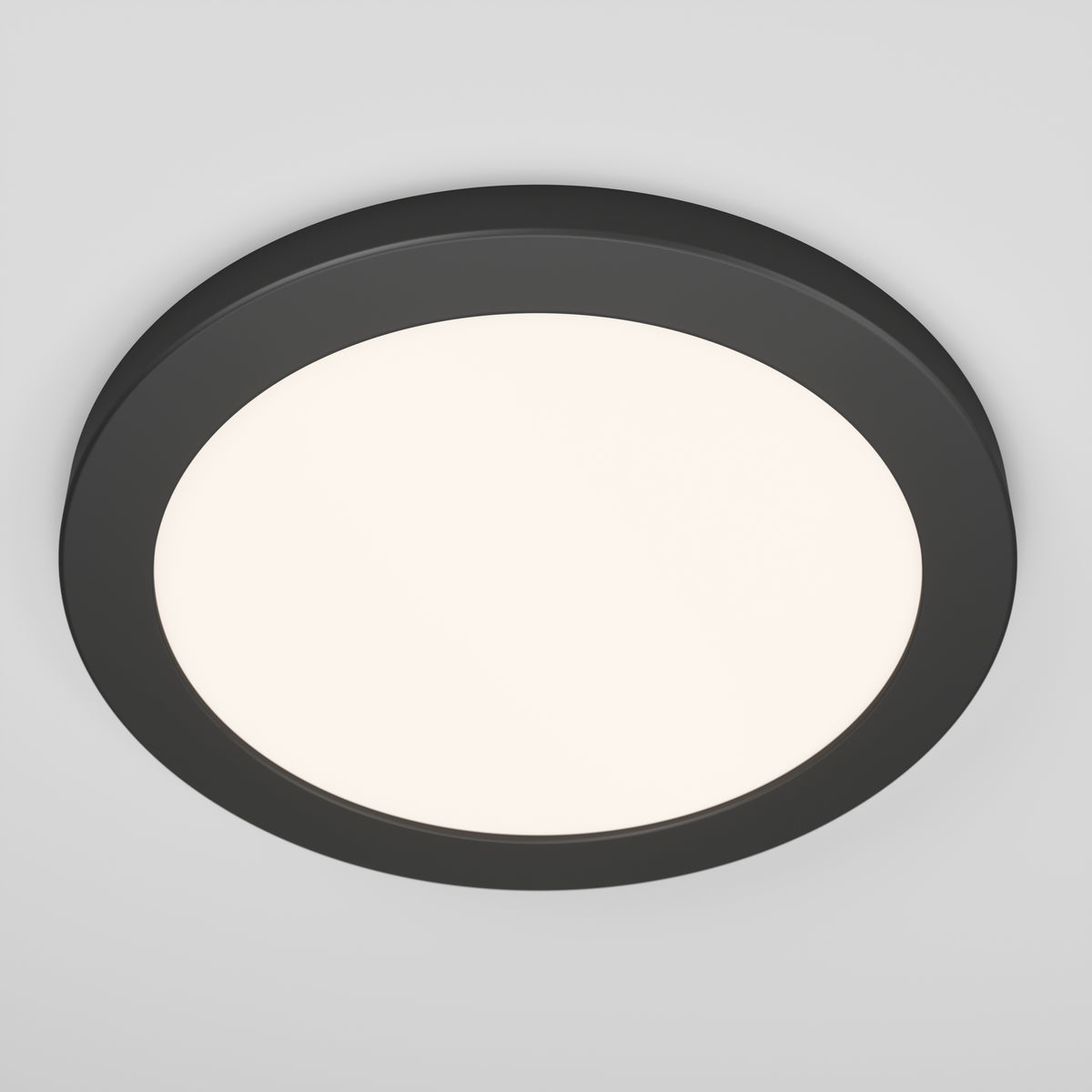 The Artika Europa Disk 9 in. LED modern flush mount light features a sleek black frame and diffused white center, installed on a plain white ceiling. It offers 3 selectable color temperatures (CCT) for versatile illumination.