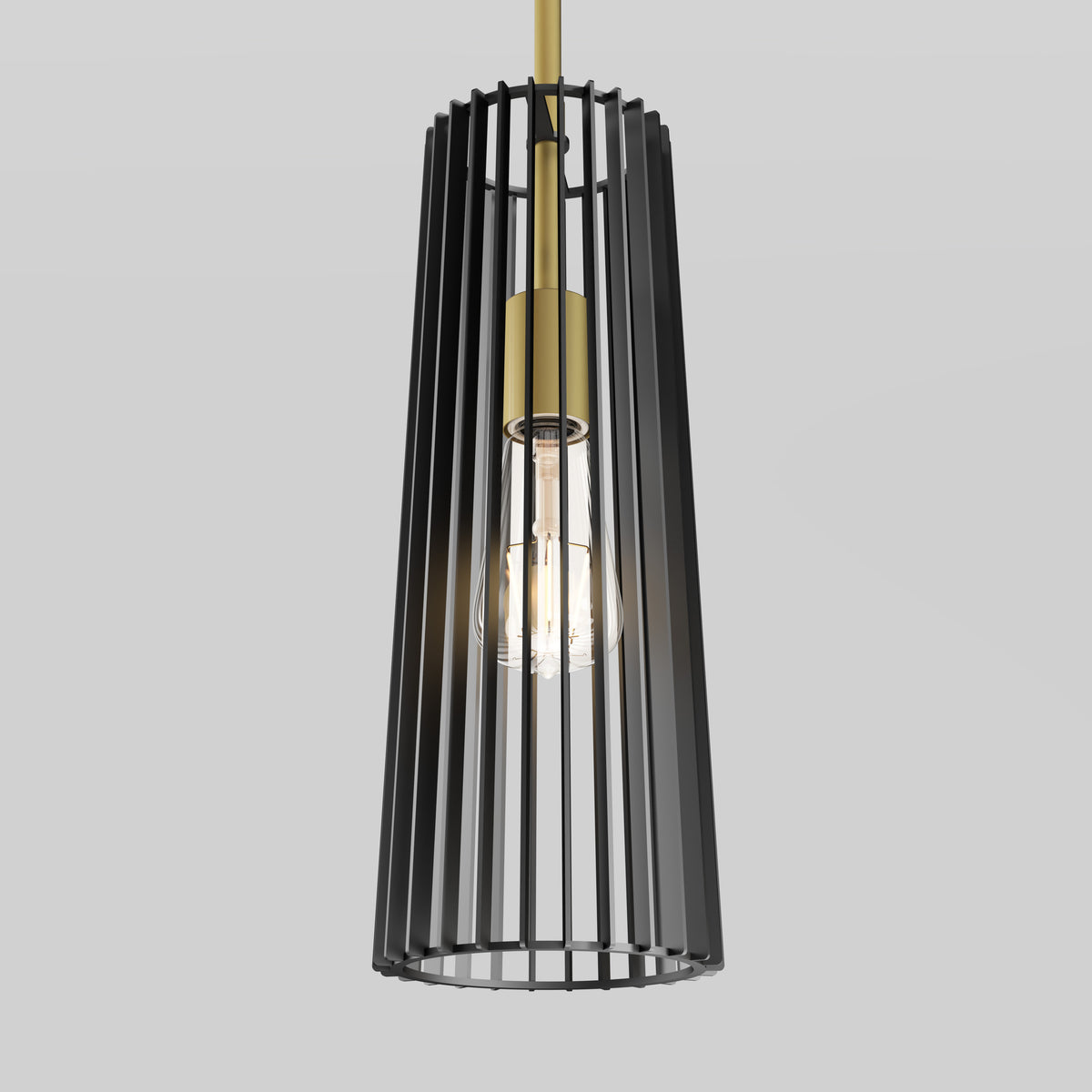 A modern pendant light with a cylindrical black metal cage surrounding a glowing exposed bulb, suspended by a gold rod against a plain light gray background.
