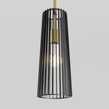 A modern pendant light with a cylindrical black metal cage surrounding a glowing exposed bulb, suspended by a gold rod against a plain light gray background.