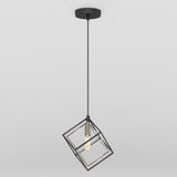 A modern pendant light with a black cord and a geometric, open cube-shaped metal frame surrounding an exposed light bulb, hanging from a round ceiling mount against a plain white background.