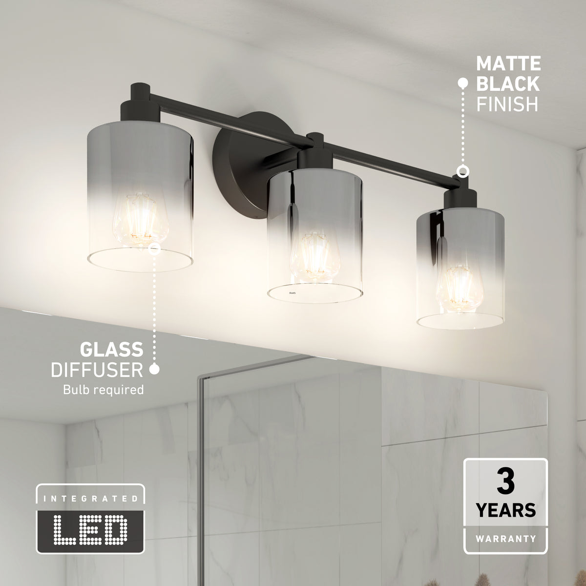A modern bathroom wall light fixture with three cylindrical glass diffusers, each containing a visible bulb. The fixture has a matte black finish and is mounted above a mirror. Text highlights integrated LED and a 3-year warranty.