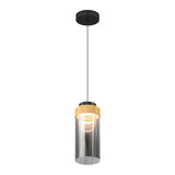 A modern pendant light with a black ceiling mount, a black cord, a wooden accent near the top, and a cylindrical clear glass shade surrounding the bulb.