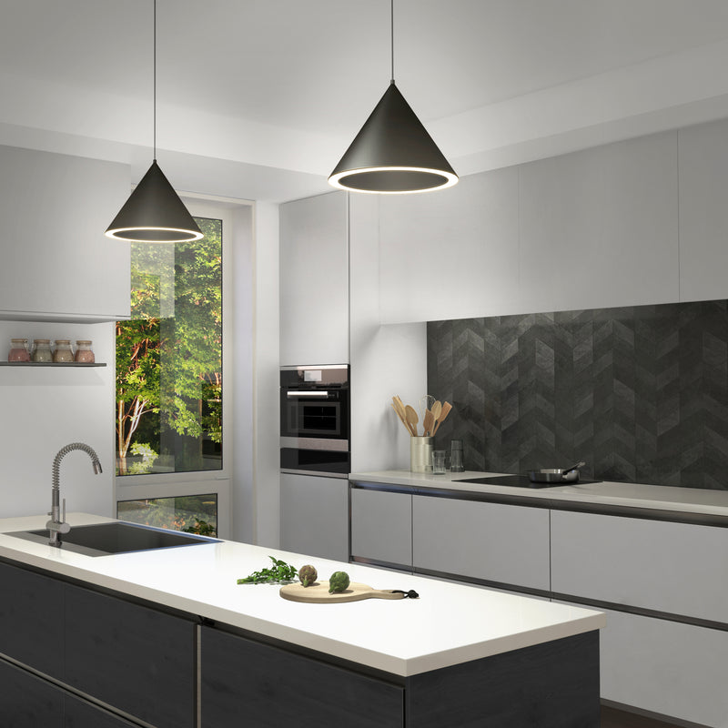 Modern kitchen with white cabinets, chevron backsplash, island sink, and large window. Cooking utensils and jars arranged on shelves. Features Artikas Denali modern LED pendant light 3 CCT above the island for stylish illumination.