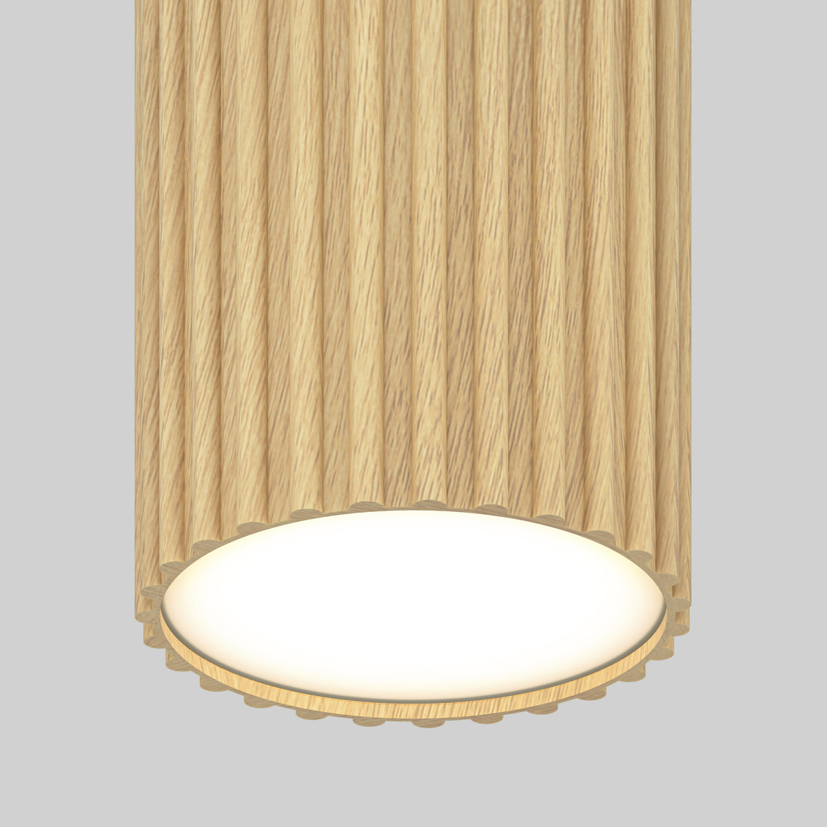 A cylindrical ceiling light fixture with a ribbed, light wood texture and a glowing white circular base, set against a plain gray background.