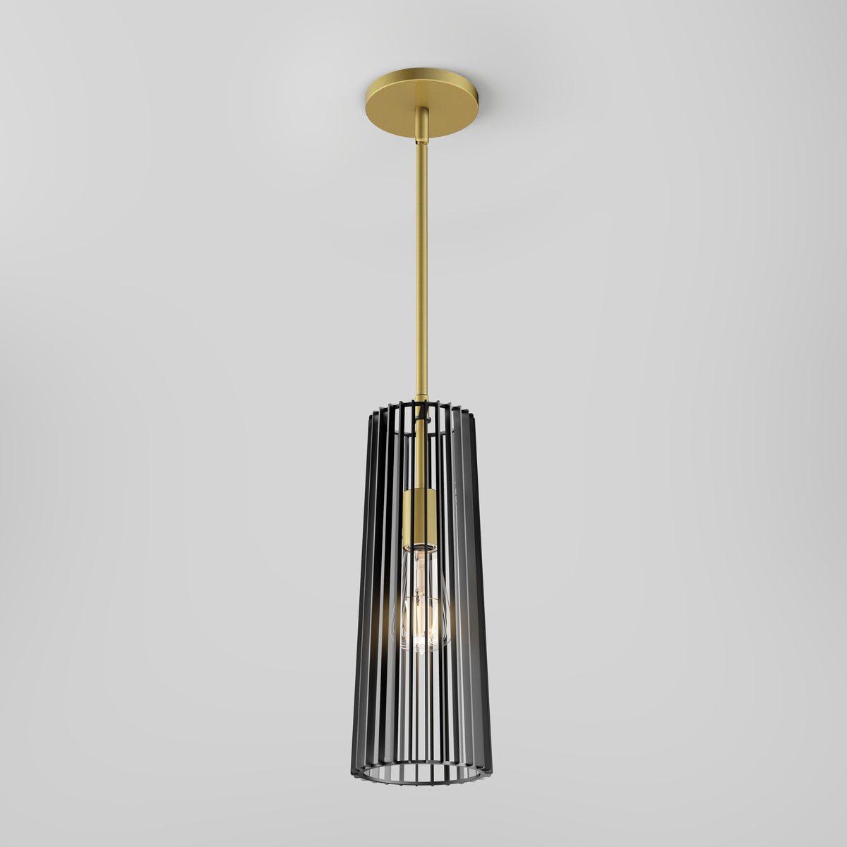 The Artika Gatsby Mini modern mid-century pendant light features a gold ceiling mount and rod, with a black metal cage-style shade encasing an exposed bulb, set against a plain white background.