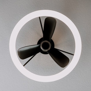The Artika Darren 23 in. LED fandelier features three black blades and a light, seen from below on a textured ceiling.