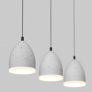 The Artika Bergen 3-light LED pendant features gray, speckled dome shades hanging against a plain light gray background, each illuminated to create a soft, modern glow.