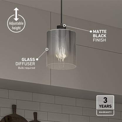 The Artika Haze pendant light glass features a clear glass diffuser, matte black finish, adjustable height, and includes a 3-year warranty. Shown above a tiled kitchen wall.