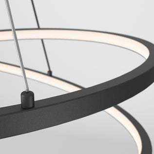 Close-up of the Artika Salto LED pendant light, featuring a modern circular black frame and suspended by thin wires against a plain light gray background.