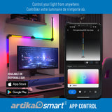 A modern desk setup with a computer monitor and RGB wall light bars, showing color-changing lights. A smartphone displays an app controlling the lights. Text promotes remote light control via the Artika Smart app.