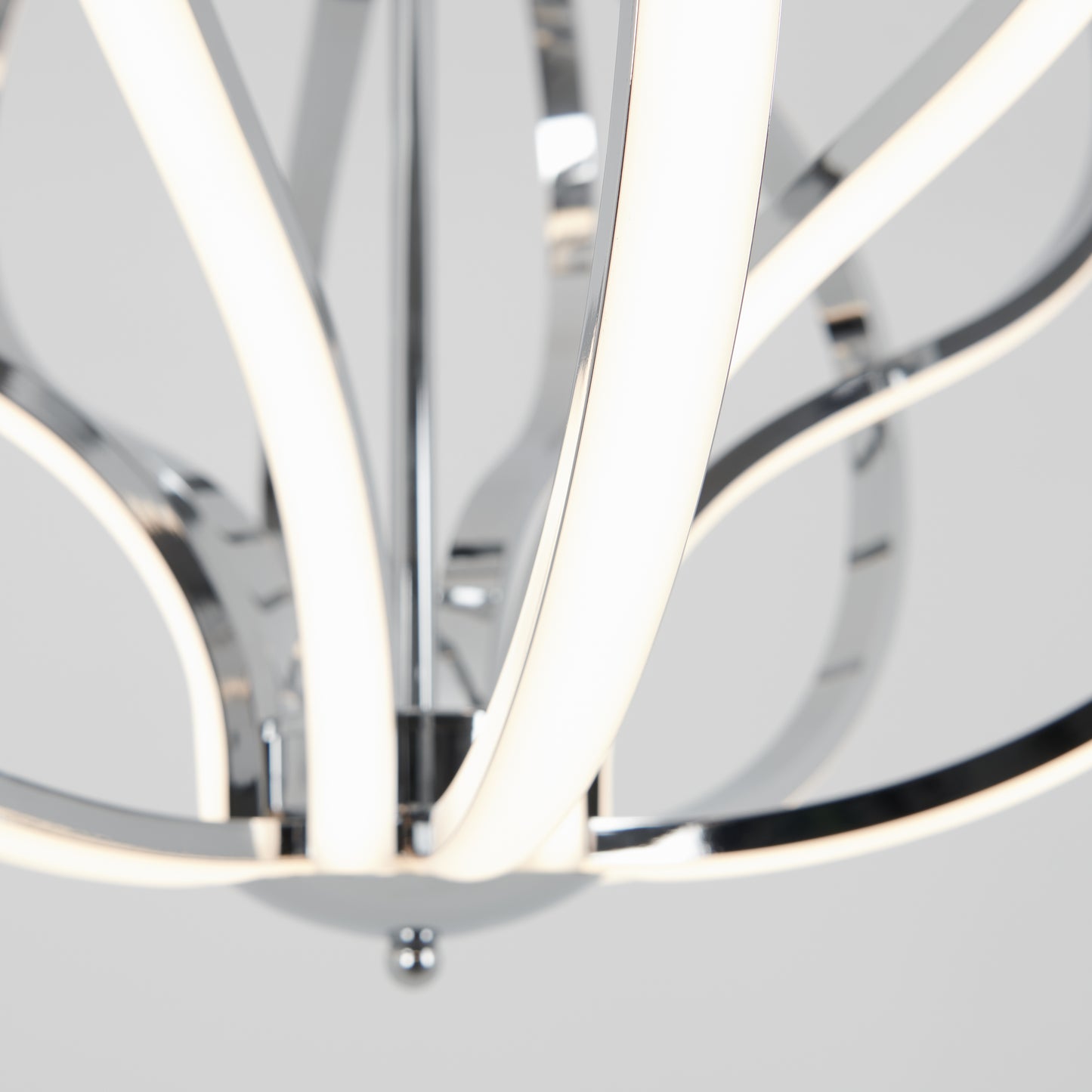 Close-up of the Artika Meridian LED pendant light, featuring curved chrome-finished arms and integrated LED strips, set against a plain light gray background.