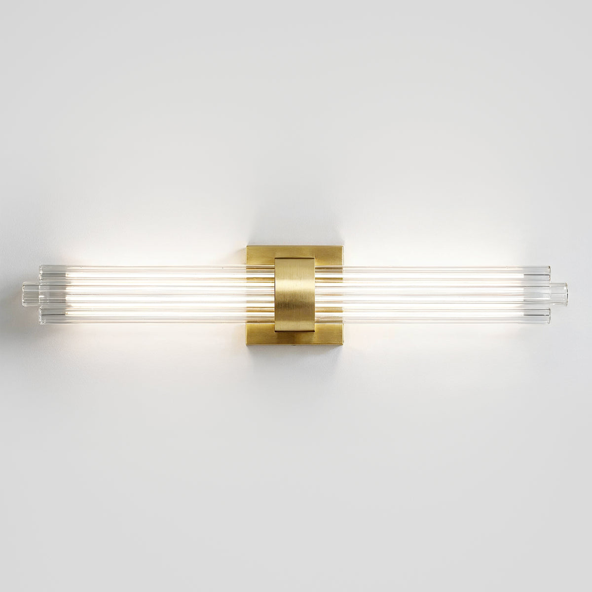 The Artika Dorado 27 in. 1-Light LED Wall Vanity offers dimmable, modern bathroom lighting with a brass accent and four glass rods.