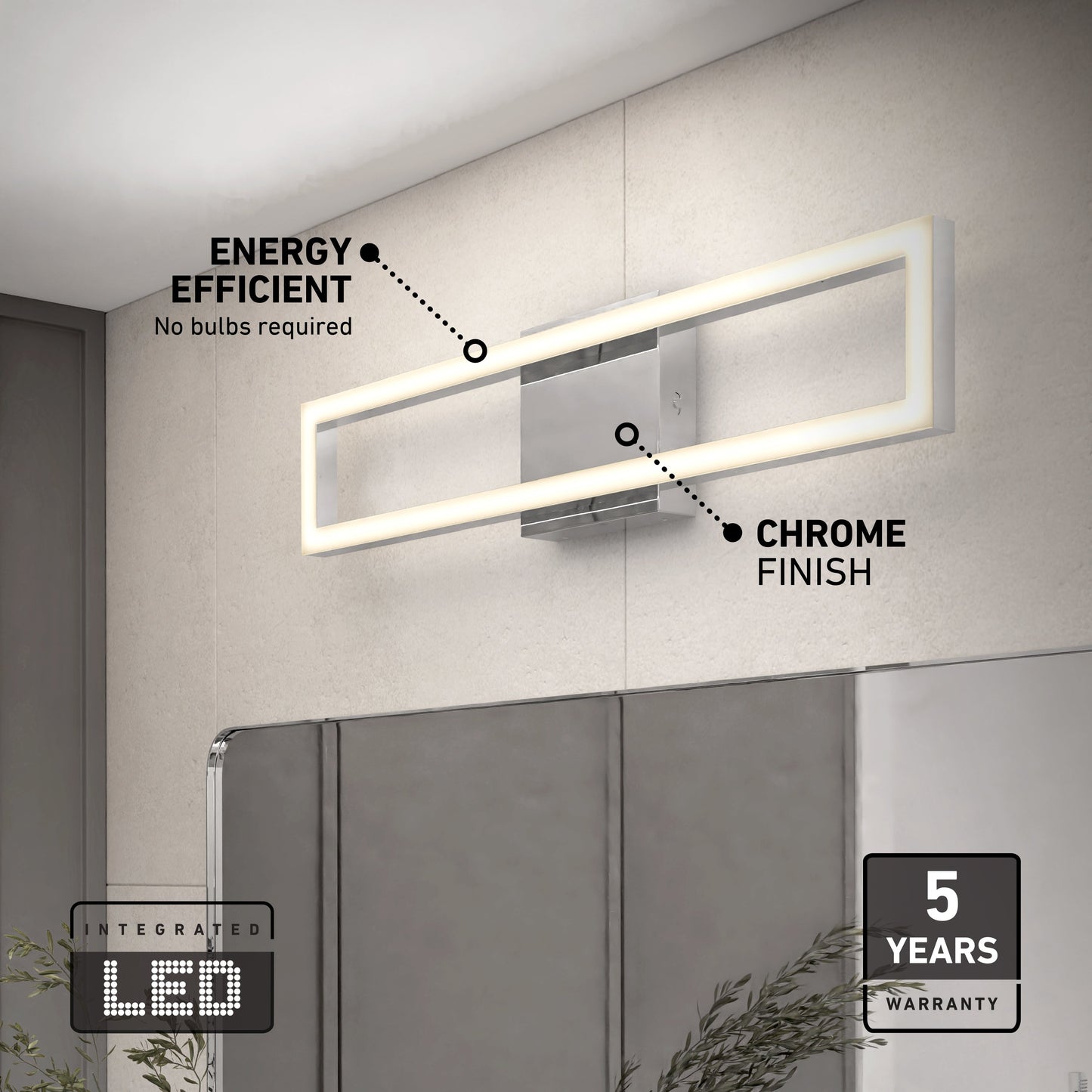 The Artika-CAN-dev Dover modern LED bathroom vanity light 5 CCT, featuring a chrome finish, is mounted above a bathroom mirror. Labels note its energy efficiency, integrated LED, and 5-year warranty. A plant sits in the lower right corner.