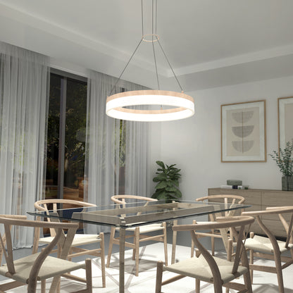 A modern dining room featuring a glass table, six wooden chairs, an Artika Optical LED pendant light 3 CCT, large windows with sheer curtains, framed abstract art on the wall, and decorative potted plants.