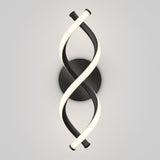A modern wall light fixture with two intertwined, LED-lit curved bars, one black and one white, forming a double helix shape on a round black base against a plain, light-colored background.