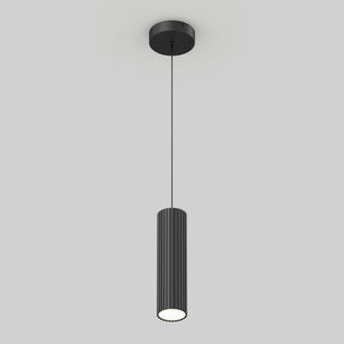 The Artika Groove LED modern pendant light 3 CCT features a black cylindrical, vertically ribbed shade hanging from a slim black cord with a round ceiling mount, set against a plain light gray background.