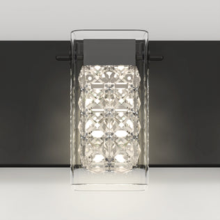 The Artika Crystal Cube LED bathroom vanity light features a clear geometric glass cover, a metallic black base, and bright white LEDs, stylishly mounted on a light gray wall.