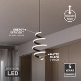 A modern spiral pendant light with an integrated LED hangs from the ceiling. Labels highlight its energy efficiency, matte black finish, adjustable height, and 5-year warranty. The room features light wood cabinets and gray curtains.