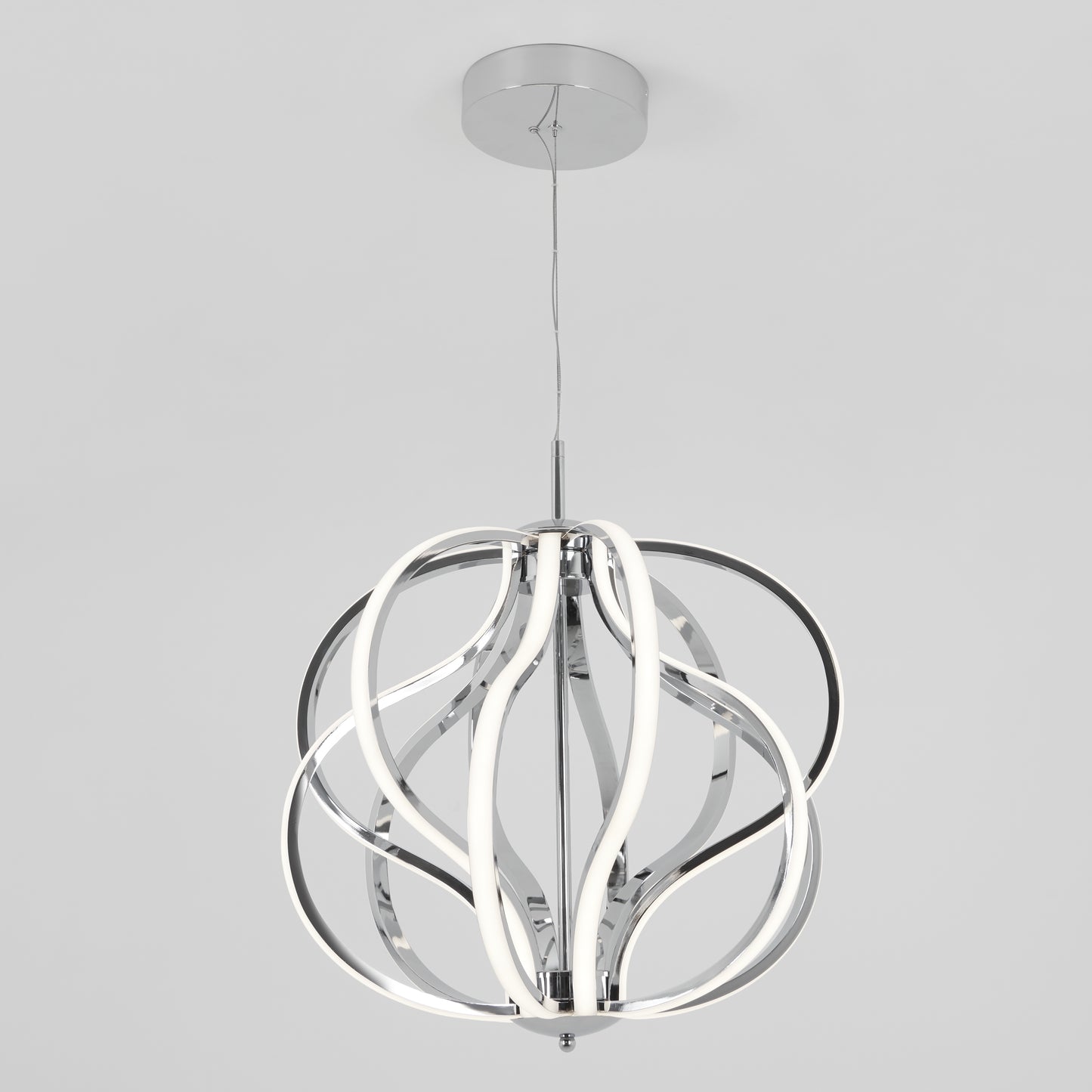 The Artika Meridian LED pendant light features curved, ribbon-like LED strips in a polished chrome finish, suspended from the ceiling by a thin cable against a plain white background.