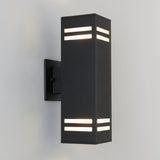 A modern black outdoor wall sconce with a rectangular shape, featuring horizontal light slits near the top and bottom, mounted on a white wall.